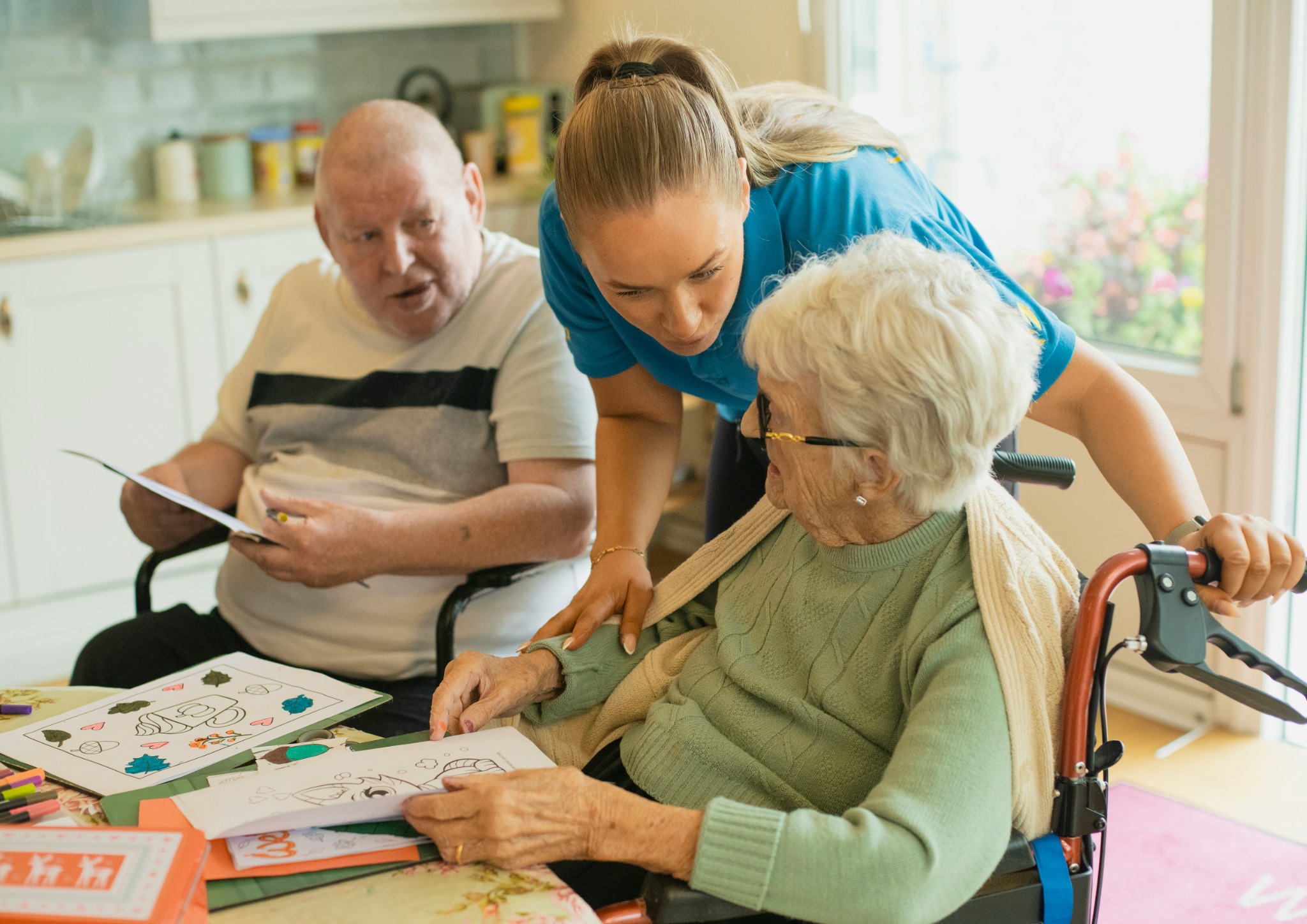 Care worker helping residents with activities